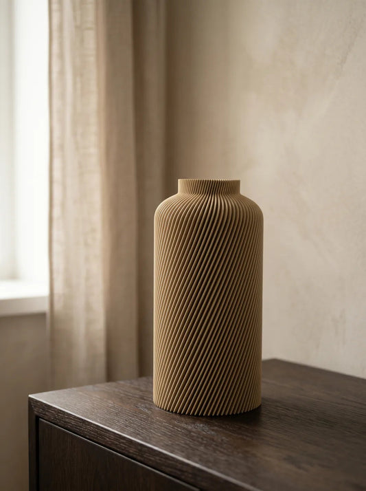 Sand-coloured Silo vase on a dark wooden cabinet beside a linen curtain