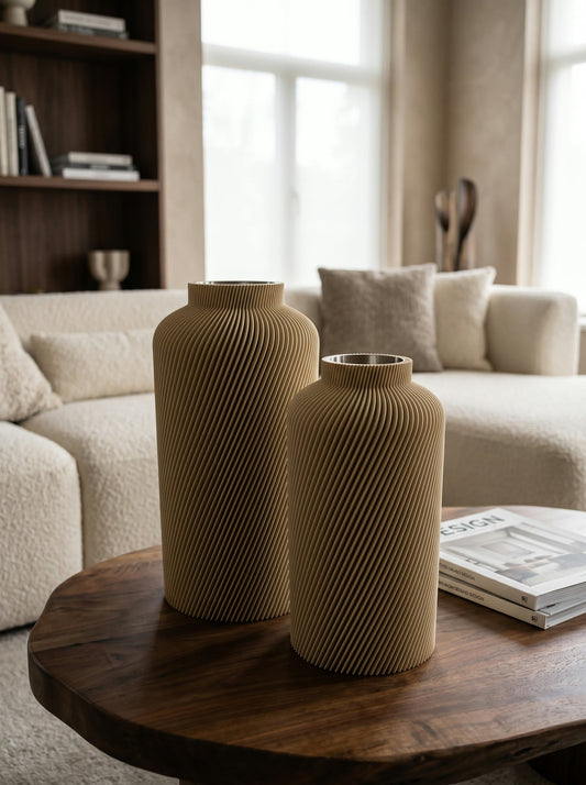 Two sand-coloured Silo vases in two heights on a round wooden table in a living room