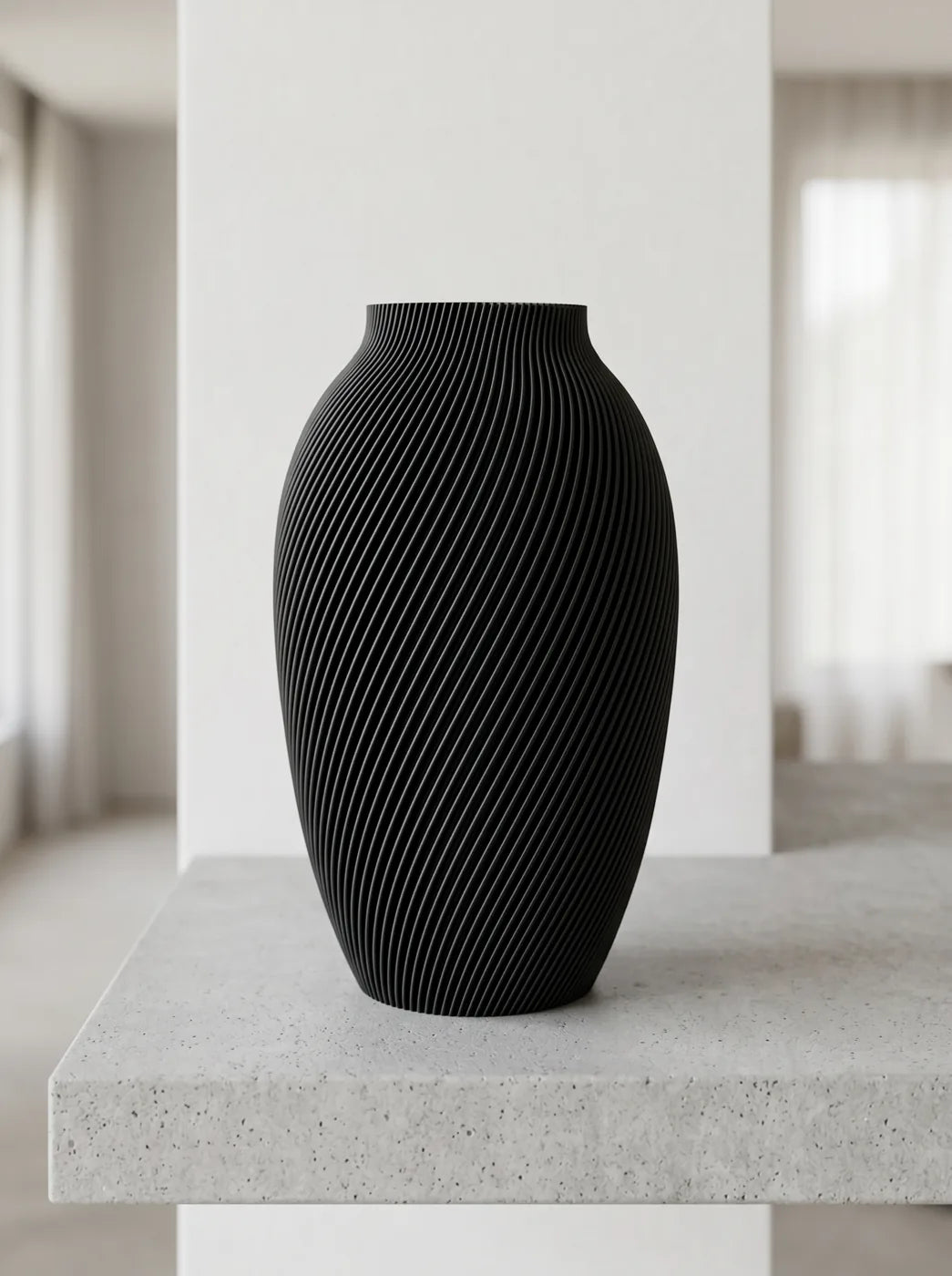 Black SPIRE vase on a stone plinth