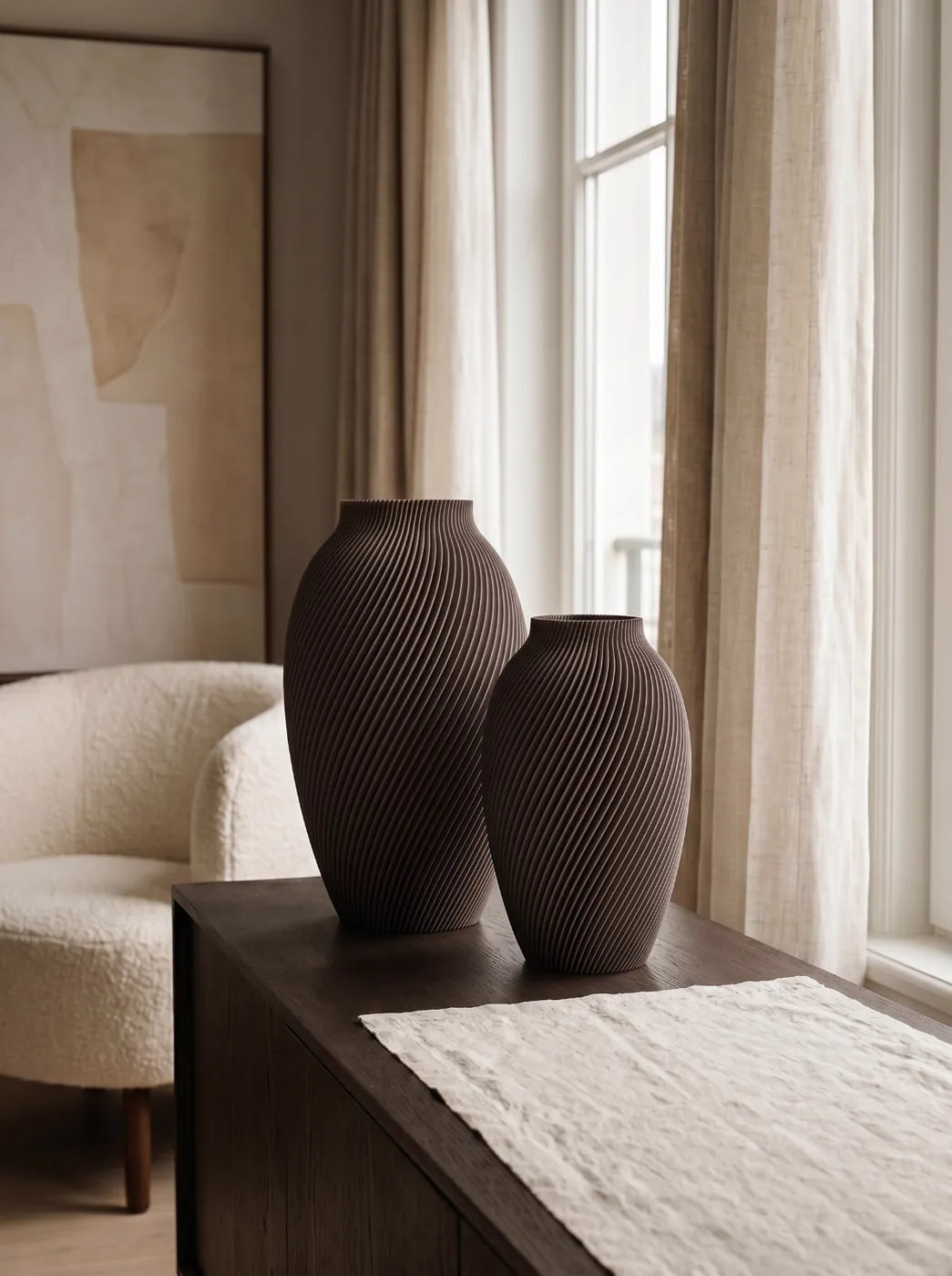 Two brown SPIRE vases on a dark wood console