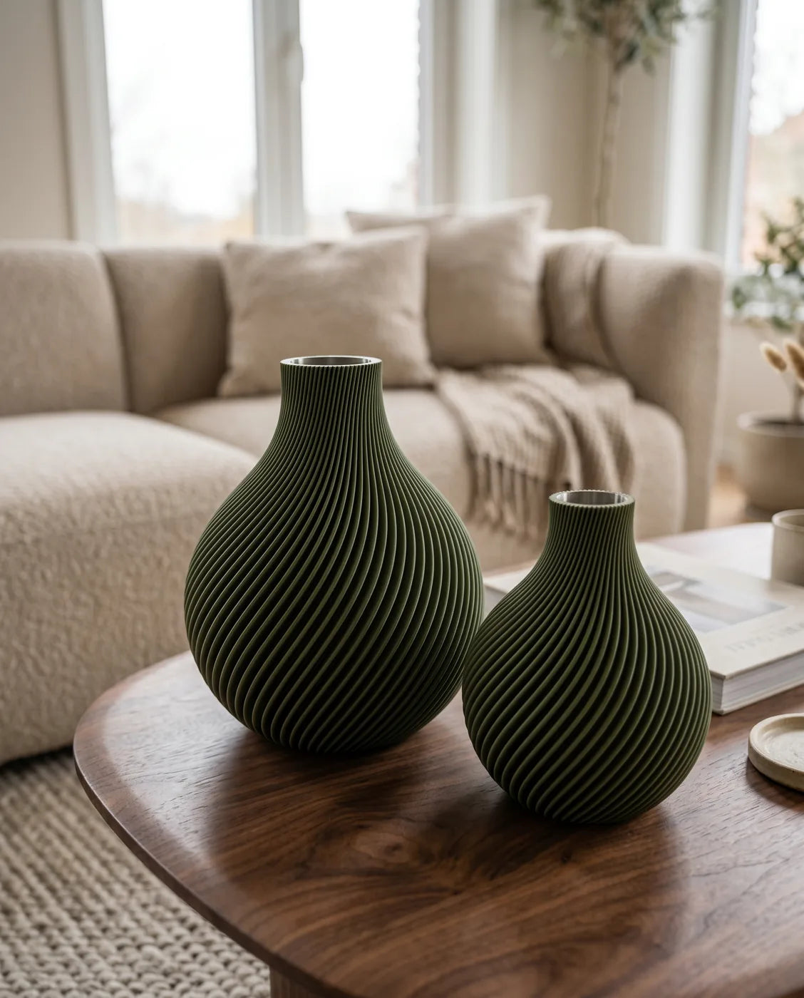 Two olive ORB vases on a walnut coffee table