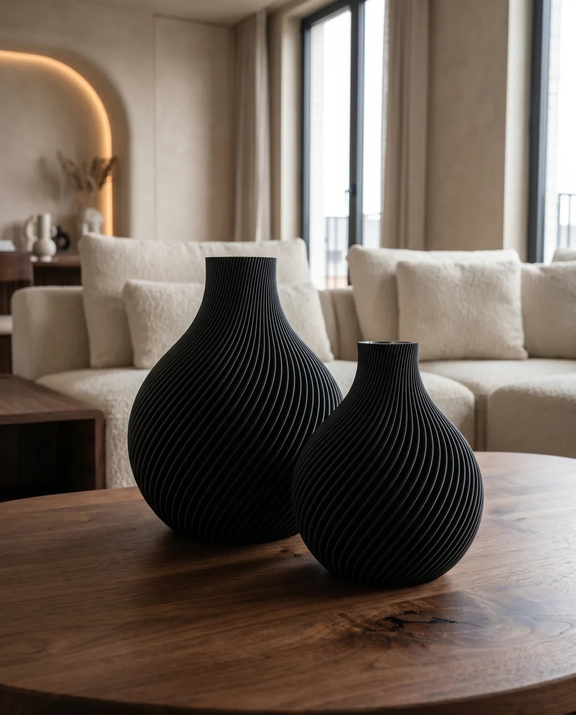 Two black ORB vases in a bright living room